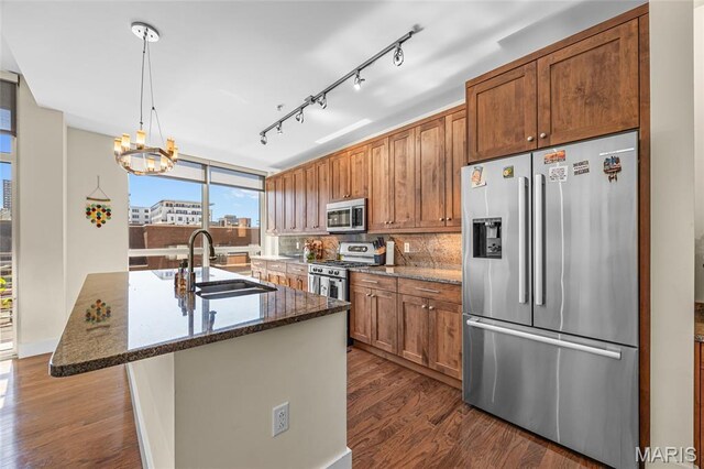 9 N Euclid Ave Unit 303, Saint Louis, MO 63108 - kitchen featuring appliances with stainless steel finishes, a sink, dark wood-type flooring, and brown cabinets