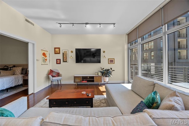 9 N Euclid Ave Unit 303, Saint Louis, MO 63108 - living area with wood finished floors, track lighting, and baseboards