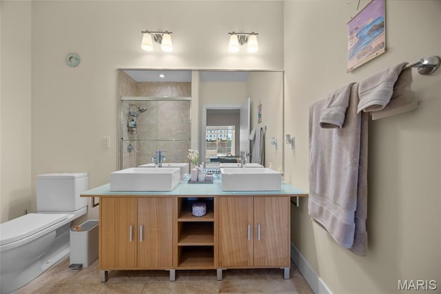 9 N Euclid Ave Unit 303, Saint Louis, MO 63108 - full bathroom featuring double vanity, toilet, a shower stall, baseboards, and tile patterned floors