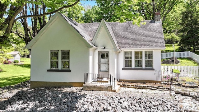 931 Sugarloaf Hill Rd, Dupo, IL 62239 - tudor home featuring a chimney, a shingled roof, fence, and stucco siding