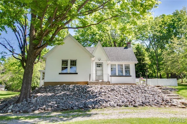 931 Sugarloaf Hill Rd, Dupo, IL 62239 - tudor home featuring stucco siding, a chimney, a shingled roof, and fence