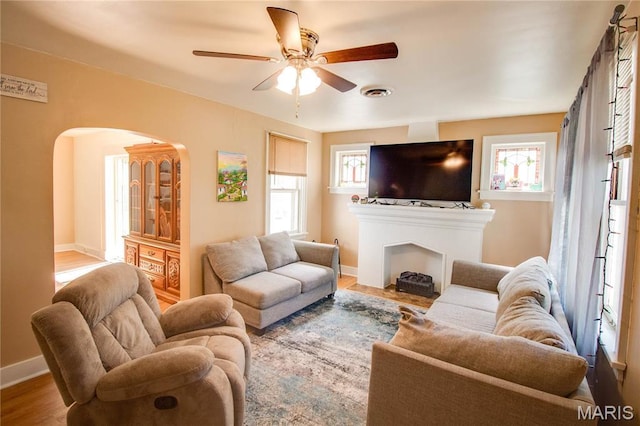 931 Sugarloaf Hill Rd, Dupo, IL 62239 - living room with arched walkways, plenty of natural light, ceiling fan, and baseboards