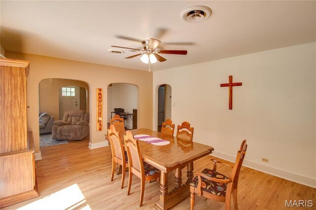 931 Sugarloaf Hill Rd, Dupo, IL 62239 - dining space with arched walkways, a ceiling fan, and light wood-style floors
