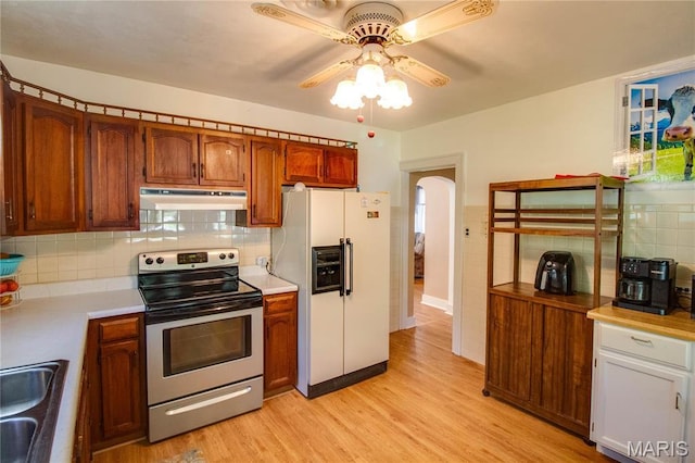 931 Sugarloaf Hill Rd, Dupo, IL 62239 - kitchen featuring stainless steel electric range, white fridge with ice dispenser, under cabinet range hood, ceiling fan, and light countertops