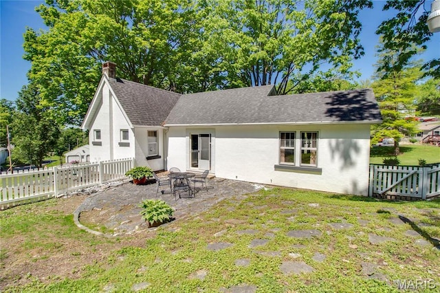 931 Sugarloaf Hill Rd, Dupo, IL 62239 - back of house featuring a patio, stucco siding, a fenced backyard, and a shingled roof