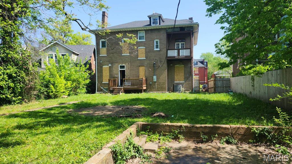 26 Lewis Pl, Saint Louis, MO 63113 - rear view of property with a wooden deck and a chimney