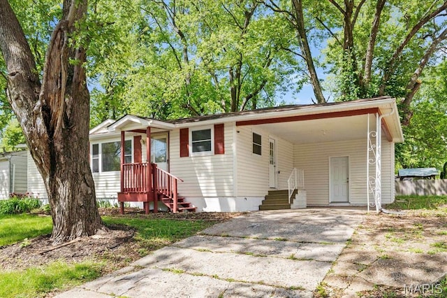 view of front of house featuring driveway and an attached carport
