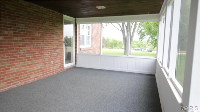 209 Highley Ln, Desloge, MO 63628 - unfurnished sunroom featuring brick wall, carpet floors, and wooden ceiling
