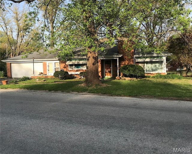 245 Oliver Lee Dr, Belleville, IL 62223 - view of front facade with a front lawn, an attached garage, brick siding, and driveway