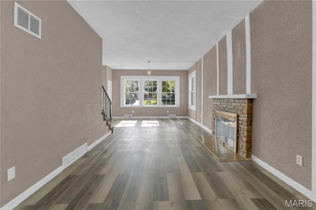 317 S Louisiana St, Cape Girardeau, MO 63703 - unfurnished living room featuring stairway, wood finished floors, baseboards, and a textured wall