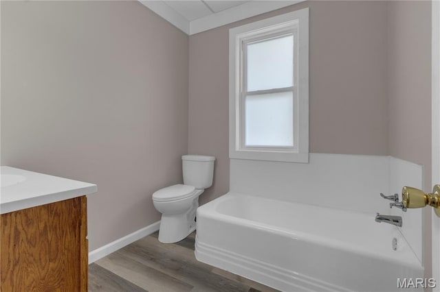 317 S Louisiana St, Cape Girardeau, MO 63703 - bathroom featuring a bath, toilet, baseboards, wood finished floors, and vanity