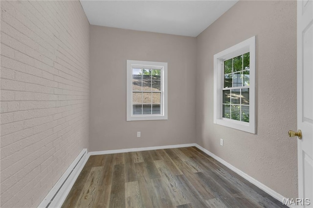 317 S Louisiana St, Cape Girardeau, MO 63703 - unfurnished room with dark wood-style floors, baseboards, and brick wall
