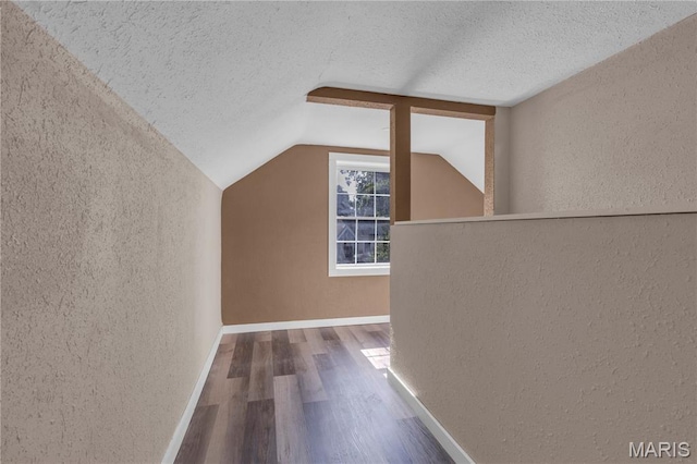 317 S Louisiana St, Cape Girardeau, MO 63703 - additional living space with a textured wall, a textured ceiling, wood finished floors, vaulted ceiling, and baseboards