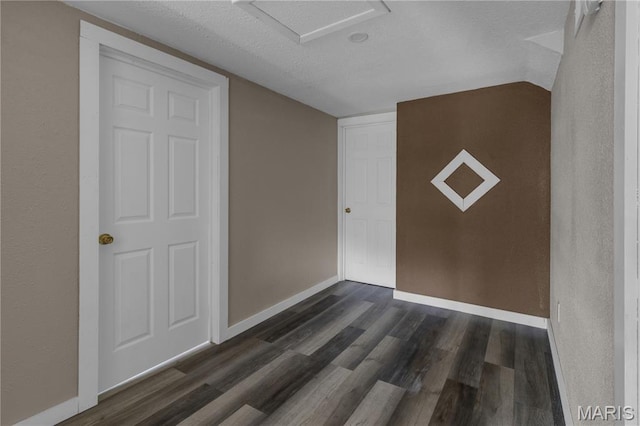 317 S Louisiana St, Cape Girardeau, MO 63703 - interior space featuring dark wood-type flooring, baseboards, a textured ceiling, attic access, and a closet