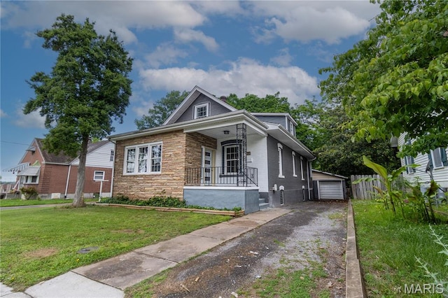 317 S Louisiana St, Cape Girardeau, MO 63703 - bungalow featuring covered porch, an outbuilding, stone siding, and a detached garage