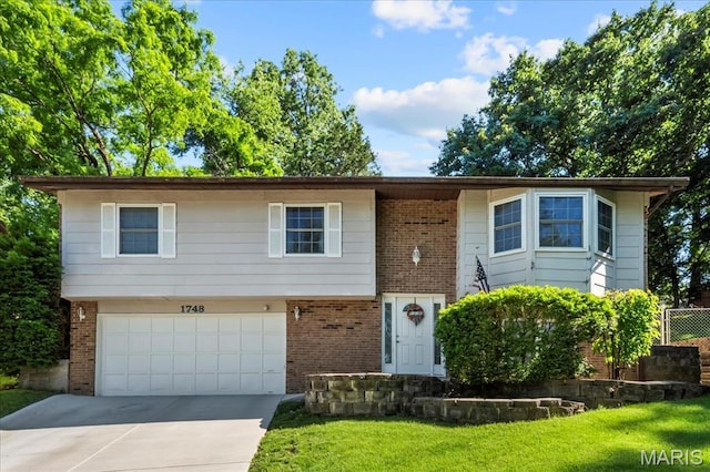 1748 Scenic Meadows Dr, Imperial, MO 63052 - view of front facade with brick siding, concrete driveway, an attached garage, and a front lawn