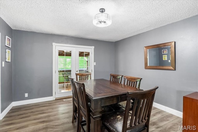1748 Scenic Meadows Dr, Imperial, MO 63052 - dining space featuring a textured ceiling, wood finished floors, and baseboards
