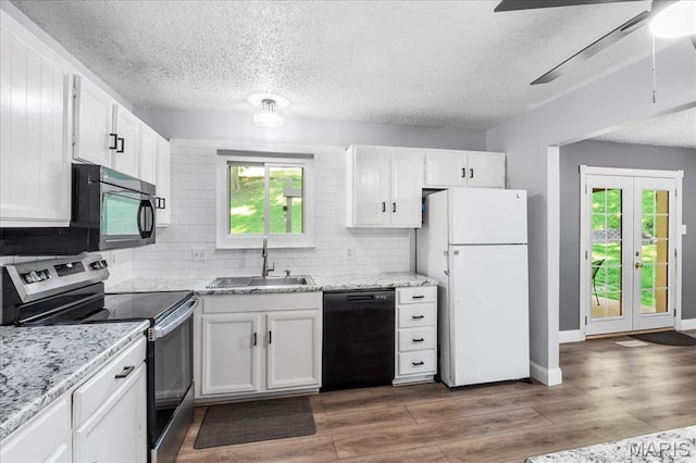 1748 Scenic Meadows Dr, Imperial, MO 63052 - kitchen with black appliances, a sink, a textured ceiling, white cabinetry, and tasteful backsplash