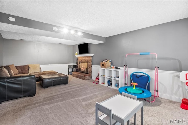 1748 Scenic Meadows Dr, Imperial, MO 63052 - rec room featuring a textured ceiling, carpet, a fireplace, and a wainscoted wall