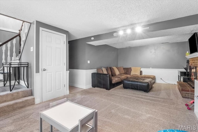 1748 Scenic Meadows Dr, Imperial, MO 63052 - living area with carpet floors, a textured ceiling, stairway, a wainscoted wall, and a fireplace