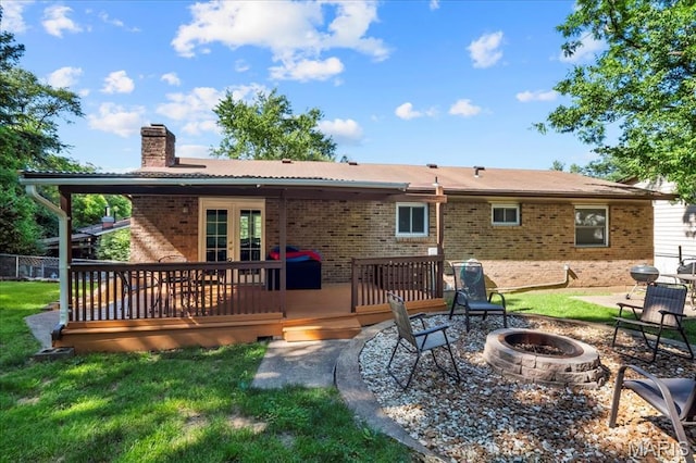 1748 Scenic Meadows Dr, Imperial, MO 63052 - rear view of house featuring an outdoor fire pit, french doors, a chimney, brick siding, and a wooden deck