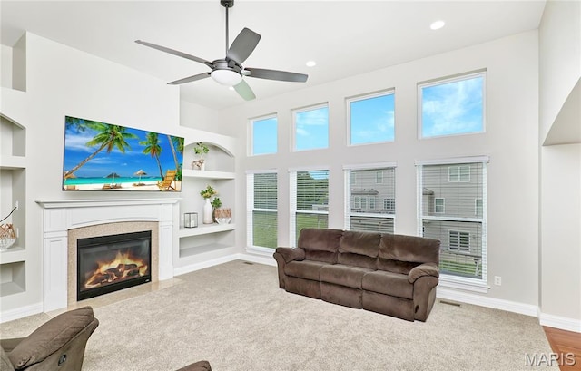3 Lakeview Pointe Ct, Lake St Louis, MO 63367 - carpeted living room with built in shelves, baseboards, a fireplace with flush hearth, a ceiling fan, and recessed lighting