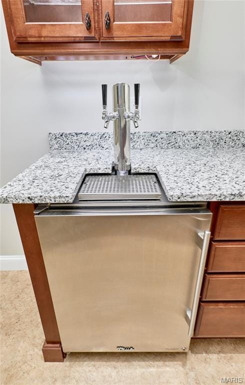 3 Lakeview Pointe Ct, Lake St Louis, MO 63367 - kitchen view of brown cabinetry, light stone countertops, and baseboards