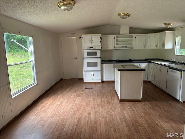 2557 River Bend Rd, Saint Clair, MO 63077 - kitchen featuring white appliances, vaulted ceiling, dark countertops, wood finished floors, and a center island