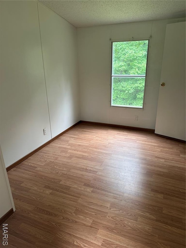 2557 River Bend Rd, Saint Clair, MO 63077 - unfurnished room with wood finished floors and a textured ceiling