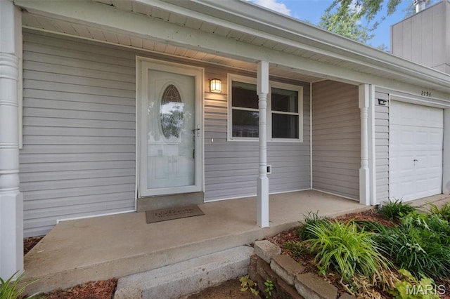 2794 Pinebrook Dr, Arnold, MO 63010 - view of exterior entry with a porch and a garage