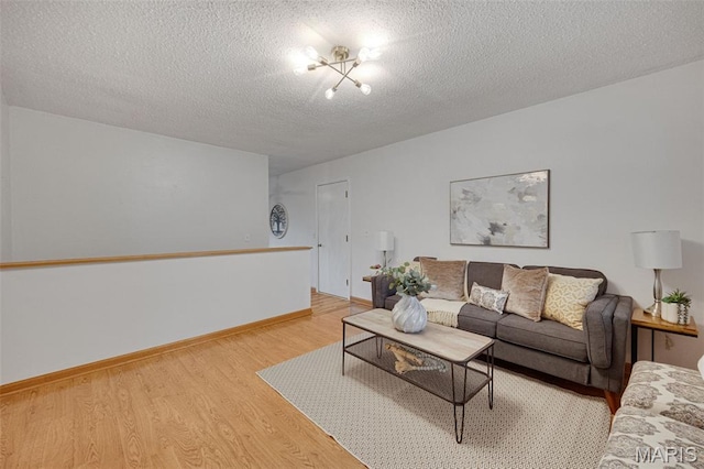 2794 Pinebrook Dr, Arnold, MO 63010 - living area featuring light wood finished floors, a textured ceiling, and baseboards