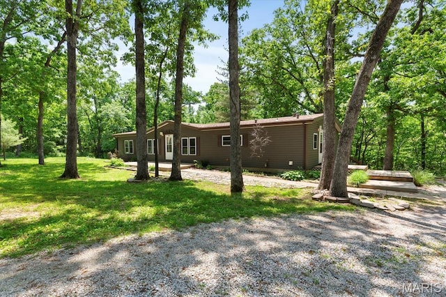 view of home's exterior featuring a lawn and view of scattered trees