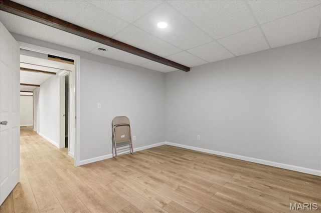empty room featuring light wood finished floors, recessed lighting, and baseboards