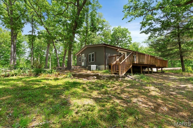 view of home's exterior with a deck, stairway, and central air condition unit