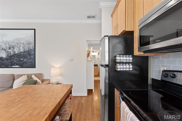 5621 Pershing Ave Unit 21, Saint Louis, MO 63112 - kitchen featuring stainless steel appliances, ornamental molding, light wood-type flooring, light brown cabinets, and decorative backsplash