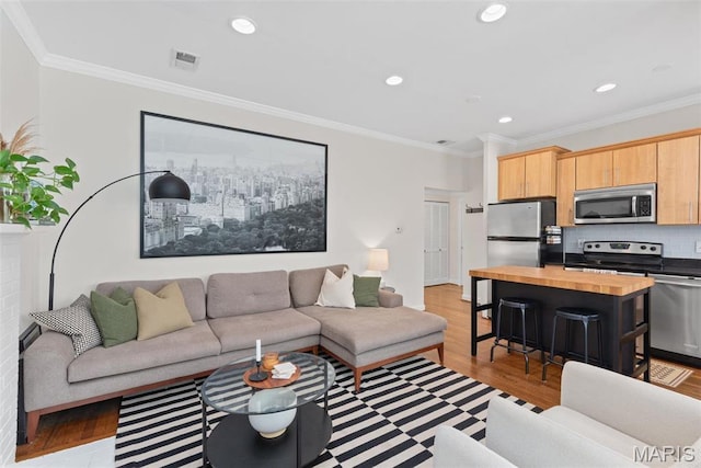 5621 Pershing Ave Unit 21, Saint Louis, MO 63112 - living area with light wood-style flooring, ornamental molding, and recessed lighting