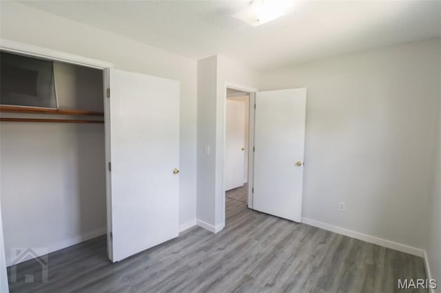 104 Wild Rose Pl, Saint Robert, MO 65584 - unfurnished bedroom featuring wood finished floors and a closet