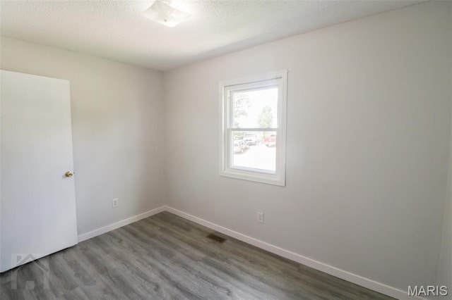 104 Wild Rose Pl, Saint Robert, MO 65584 - empty room with wood finished floors and a textured ceiling