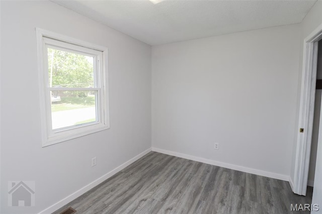 104 Wild Rose Pl, Saint Robert, MO 65584 - unfurnished room featuring wood finished floors and baseboards