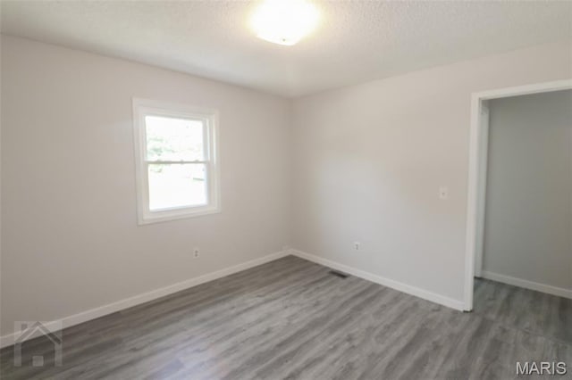 104 Wild Rose Pl, Saint Robert, MO 65584 - empty room with wood finished floors and a textured ceiling