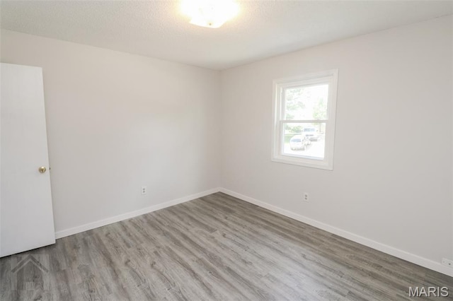 104 Wild Rose Pl, Saint Robert, MO 65584 - unfurnished room featuring wood finished floors and baseboards
