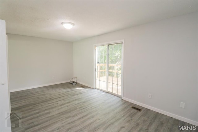 104 Wild Rose Pl, Saint Robert, MO 65584 - unfurnished room with wood finished floors and a textured ceiling
