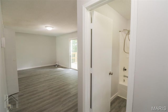 104 Wild Rose Pl, Saint Robert, MO 65584 - hallway with dark wood-type flooring and a textured ceiling