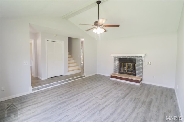 104 Wild Rose Pl, Saint Robert, MO 65584 - unfurnished living room with a ceiling fan, wood finished floors, stairway, and a fireplace