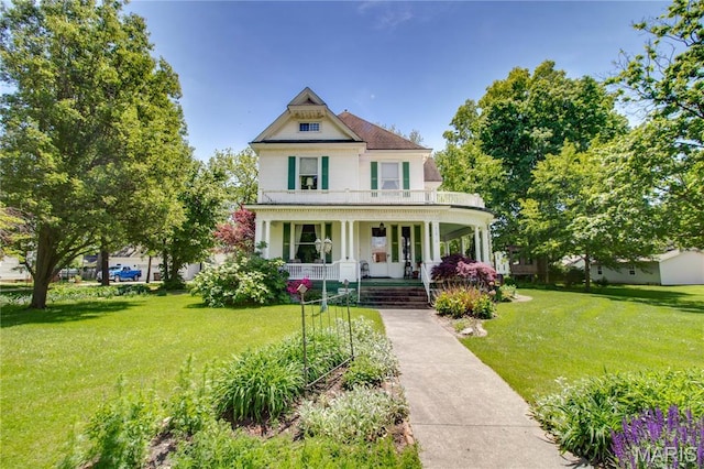 619 E Main St, Carlinville, IL 62626 - victorian-style house featuring covered porch and a front lawn