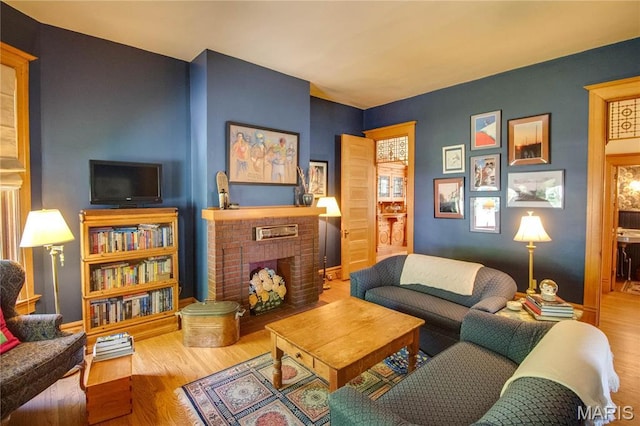 619 E Main St, Carlinville, IL 62626 - living area with wood finished floors, a fireplace, and baseboards