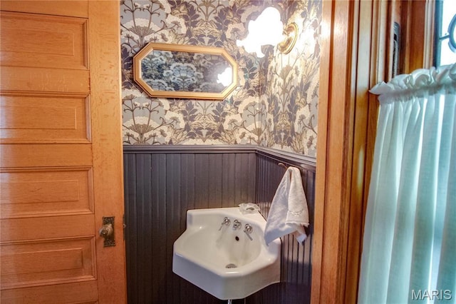 619 E Main St, Carlinville, IL 62626 - bathroom with wallpapered walls, wainscoting, and a sink
