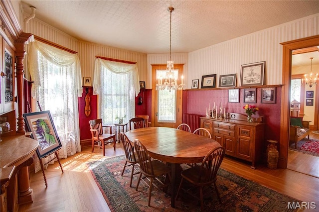 619 E Main St, Carlinville, IL 62626 - dining space featuring a chandelier, wood finished floors, and wallpapered walls