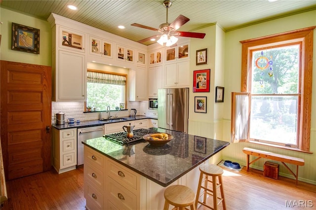 619 E Main St, Carlinville, IL 62626 - kitchen with appliances with stainless steel finishes, a sink, wood finished floors, a kitchen breakfast bar, and ceiling fan