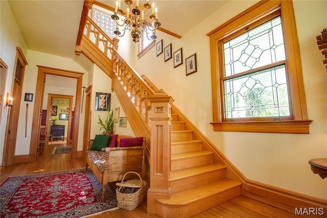 619 E Main St, Carlinville, IL 62626 - staircase with wood finished floors, a chandelier, and baseboards